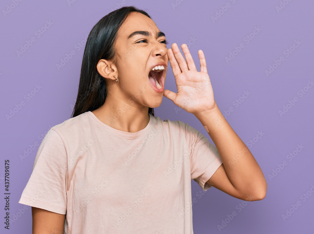 Young asian woman wearing casual clothes shouting and screaming loud to side with hand on mouth. communication concept. Young asian woman wearing casual clothes shouting and screaming loud to side with hand on mouth. communication concept.