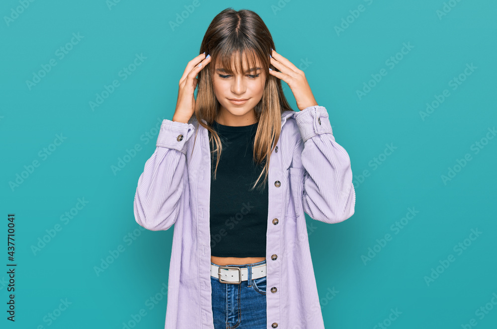 Teenager caucasian girl wearing casual clothes with hand on head for pain in head because stress. suffering migraine. Teenager caucasian girl wearing casual clothes with hand on head for pain in head because stress. suffering migraine.