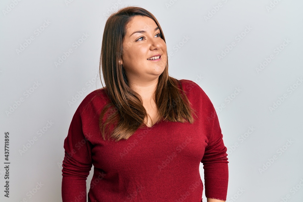 Beautiful brunette plus size woman wearing casual clothes looking to side, relax profile pose with natural face and confident smile. Beautiful brunette plus size woman wearing casual clothes looking to side, relax profile pose with natural face and confident smile.