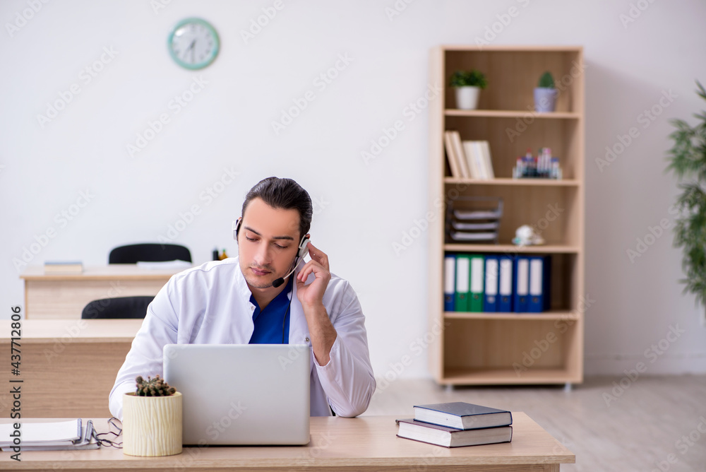 Young male doctor in telemedicine concept Young male doctor in telemedicine concept