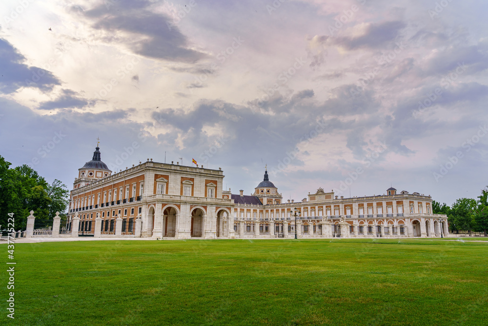 Gardens and royal palace of Aranjuez in cloudy day at sunset. Madrid.