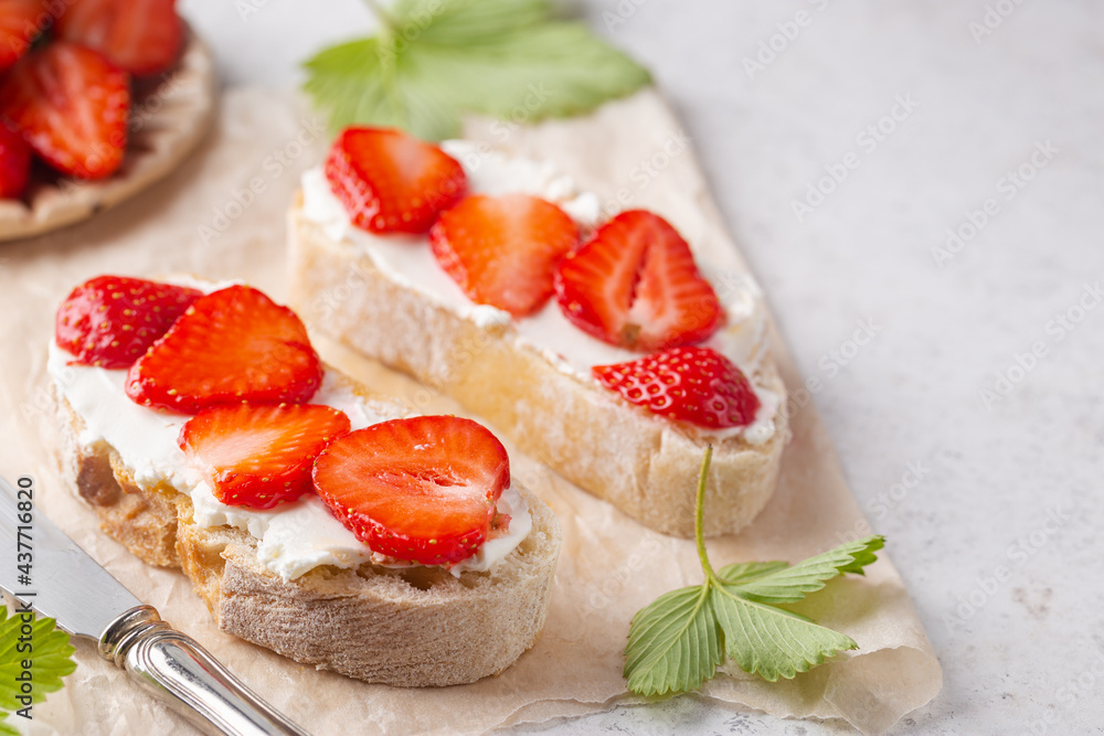 Strawberries sandwiches with cream cheese and on paper, light background Strawberries sandwiches with cream cheese and on paper, light background