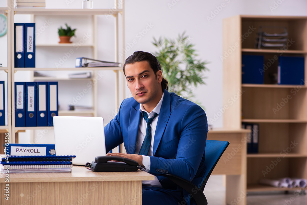 Young handsome employee sitting in the office Young handsome employee sitting in the office
