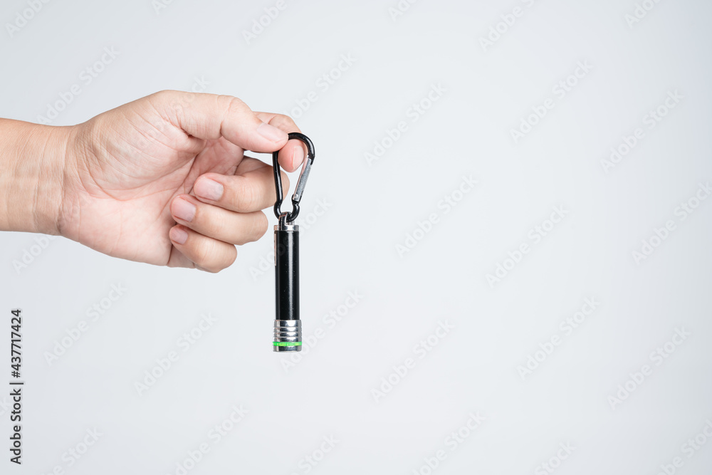 Hand holding small LED flashlight with pointing laser Hand holding small LED flashlight with pointing laser