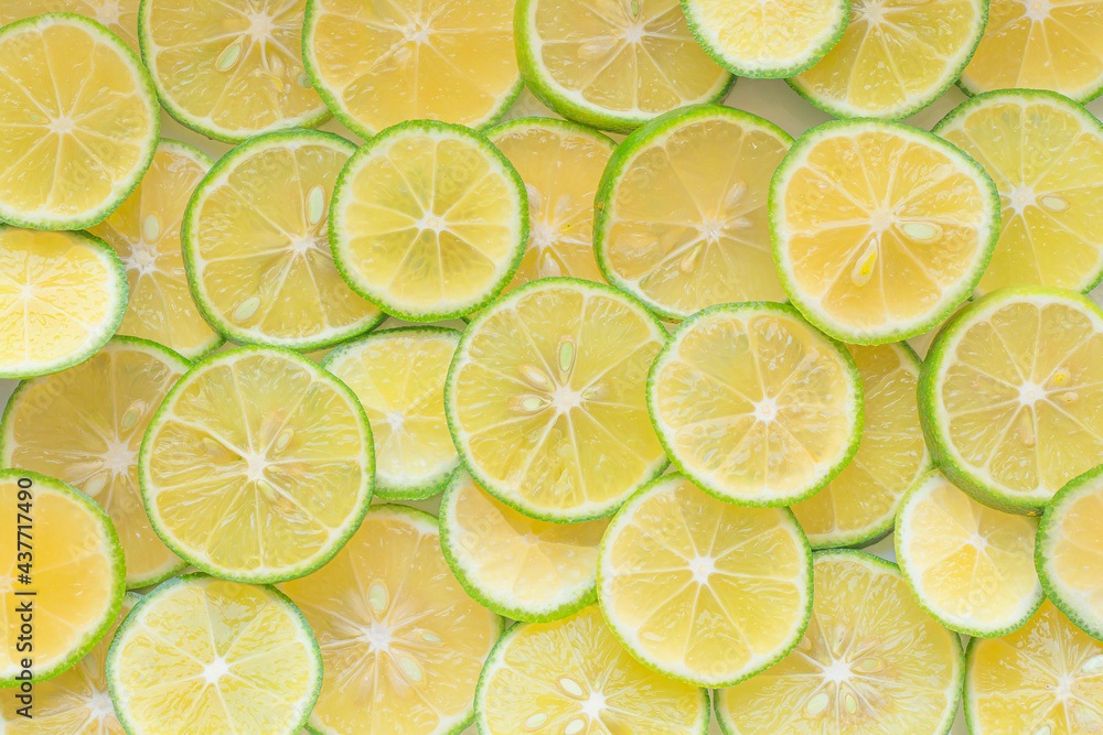 Food background. Sliced lemons neatly laid out on a white background. Suitable for use as a food background or artwork Food background. Sliced lemons neatly laid out on a white background. Suitable for use as a food background or artwork