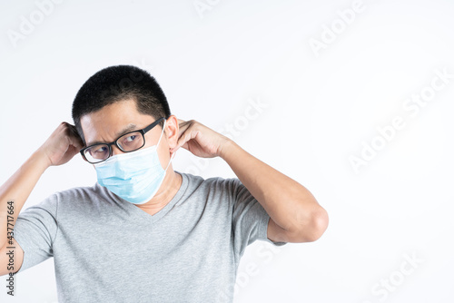 Middle aged Asian man with glasses wearing medical mask