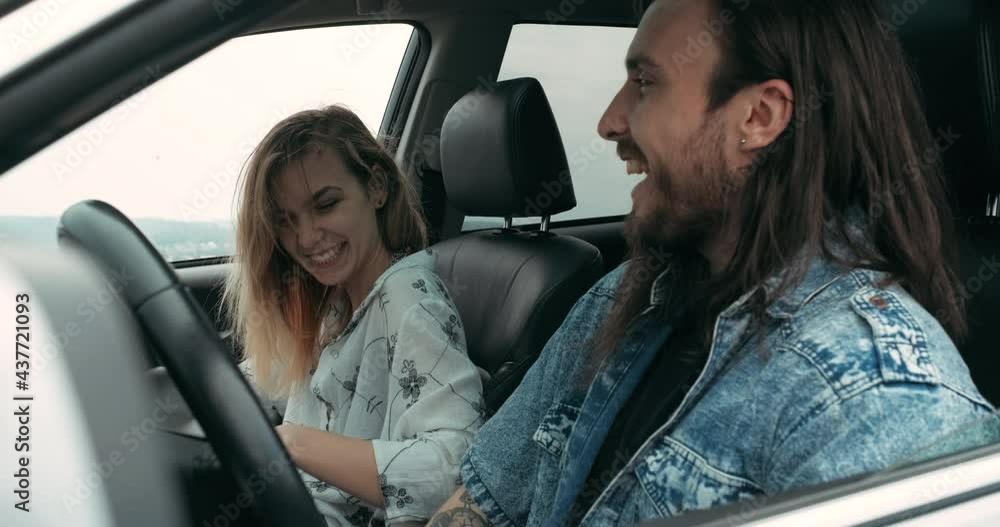 Two Young People, Man and Woman Dressed Boho Style Sitting in Their Modern Car, Road Trip and Travel Concept Two Young People, Man and Woman Dressed Boho Style Sitting in Their Modern Car, Road Trip and Travel Concept