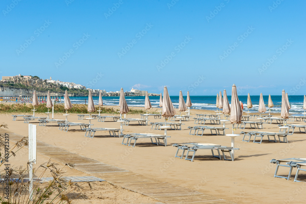 Obraz premium beach scene in Apulia Italy with umbrellas and sun loungers 