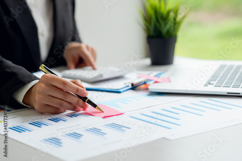 Businesswoman hands hold documents with financial statistic stock photo,discussion and analysis data the charts and graphs.Finance, Market research reports and income statistics and Accounting concept