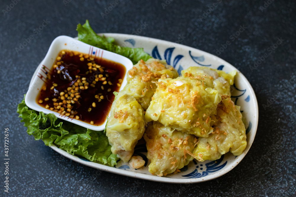 boiled dumpling or gyoza stuffed mashed pork and shrimp with topping fried chop garlic on plate dipping sweet soybean sauce boiled dumpling or gyoza stuffed mashed pork and shrimp with topping fried chop garlic on plate dipping sweet soybean sauce