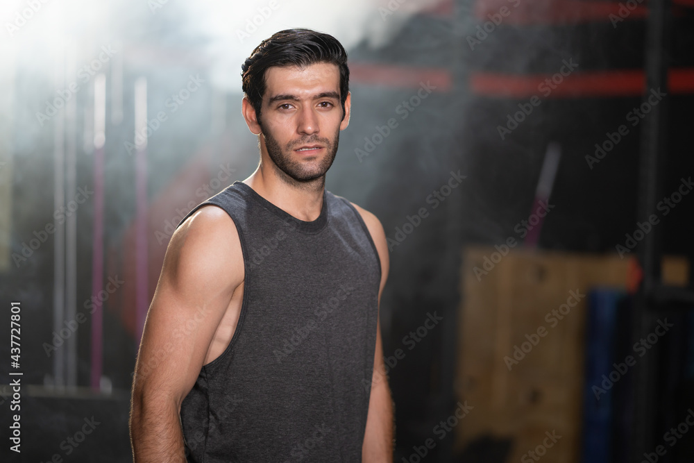 Selective focus at Caucasian men wearing sport cloth with smile inside of the gym before exercise and weight lifting inside fitness gym to workout for physical body strength and firm arms muscle Selective focus at Caucasian men wearing sport cloth with smile inside of the gym before exercise and weight lifting inside fitness gym to workout for physical body strength and firm arms muscle