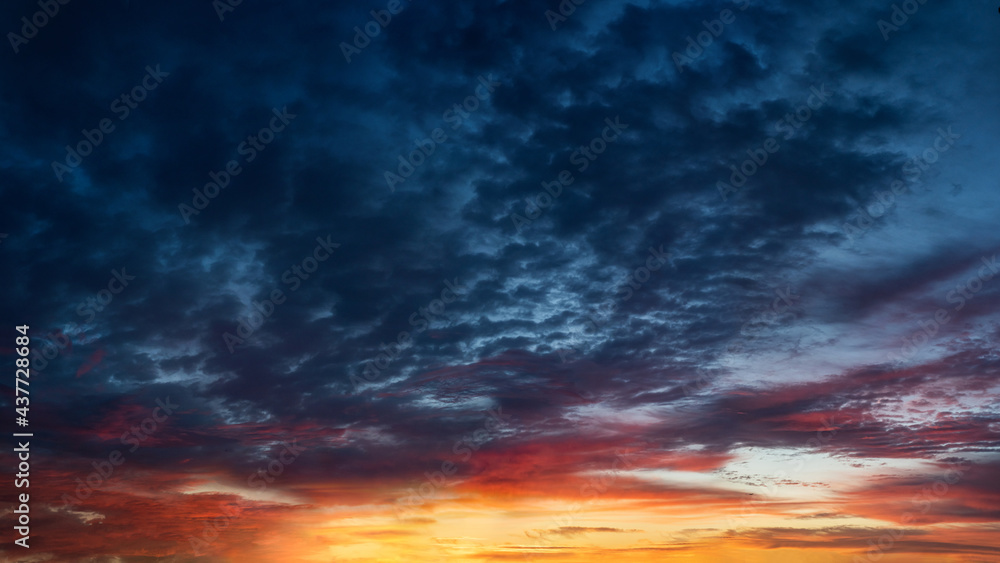 Sunset and sunrise sky. Orange, blue and yellow colors sunset. Panoramic view. Dramatic evening sky at sunset. Sunset and sunrise sky. Orange, blue and yellow colors sunset. Panoramic view. Dramatic evening sky at sunset.
