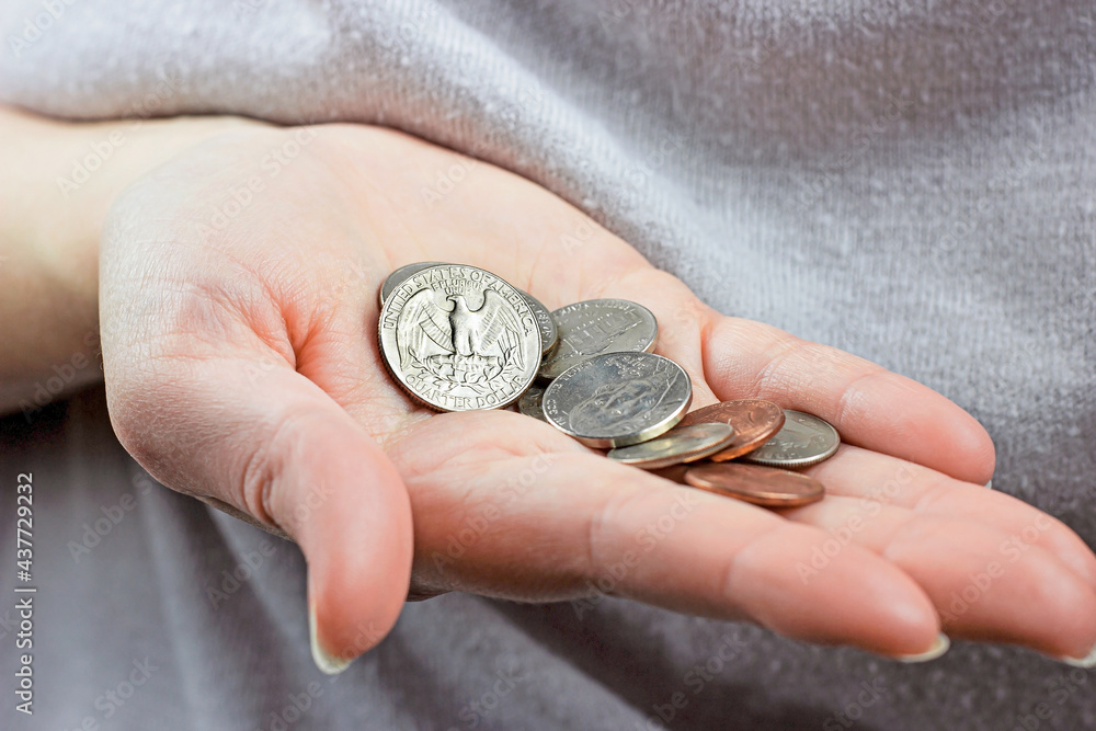 Caucasian woman hand holding and counting usa coin cents. Unemployment, poverty, savings and budget concept. Caucasian woman hand holding and counting usa coin cents. Unemployment, poverty, savings and budget concept.