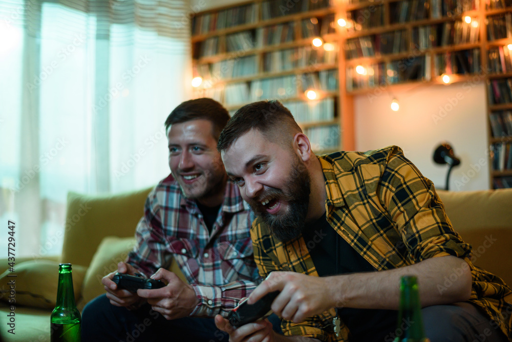Two best friends playing video games while relaxing at home