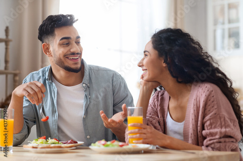 Domestic Morning. Closeup Portrait Of Happy Middle Eastern Couple Eating Breakfast Together photo
