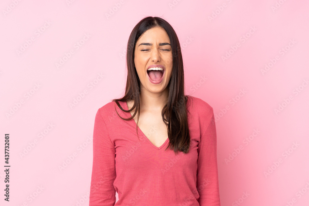 Young caucasian woman over isolated background shouting to the front with mouth wide open Young caucasian woman over isolated background shouting to the front with mouth wide open