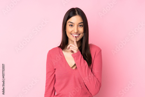 Young caucasian woman over isolated background showing a sign of silence gesture putting finger in mouth