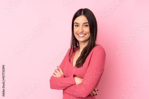 Young caucasian woman over isolated background with arms crossed and looking forward