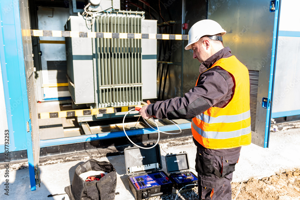 Fototapeta premium Execution of electrical measuring works on the power transformer