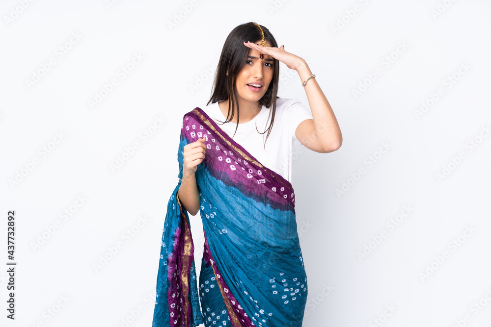Young Indian woman isolated on white background looking far away with hand to look something Young Indian woman isolated on white background looking far away with hand to look something