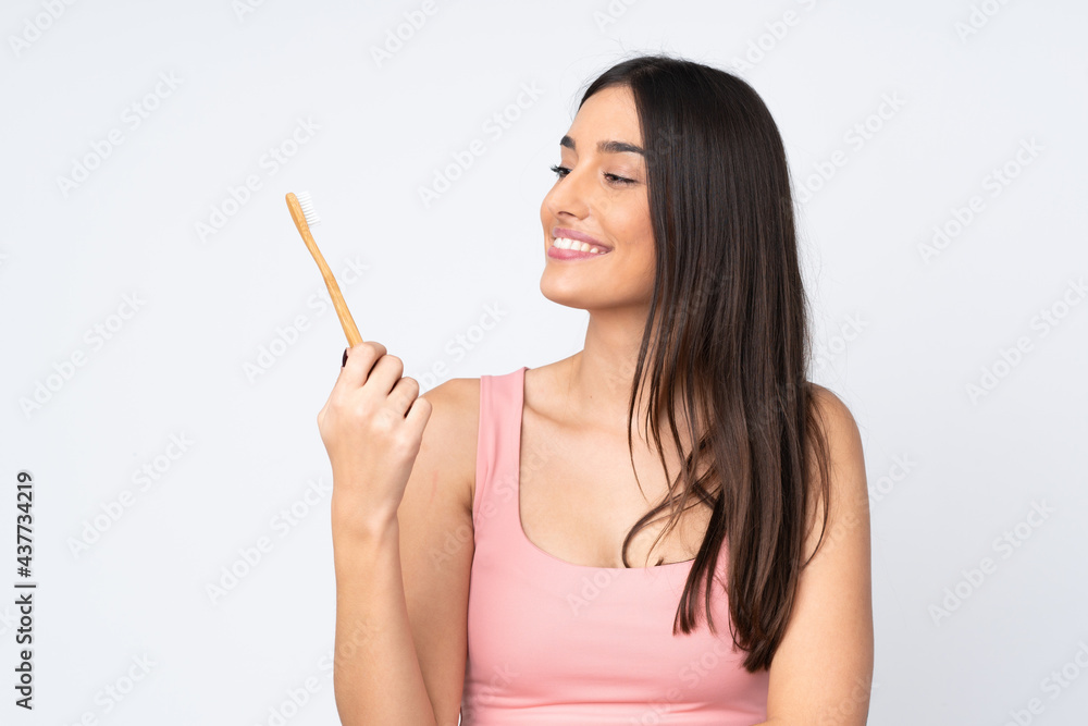 Young caucasian woman isolated on white background with a toothbrush Young caucasian woman isolated on white background with a toothbrush