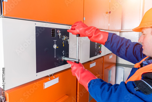 The engineer checks the absence of induced voltage on the high voltage cells photo