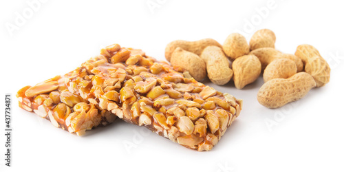 Tasty peanut brittle on white background photo
