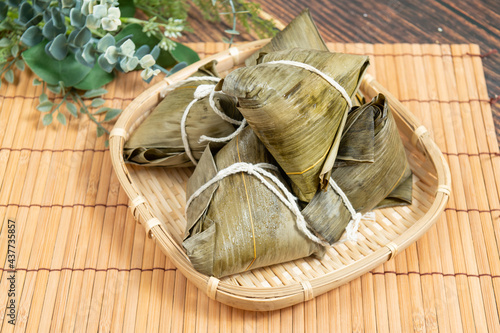 rice dumpling is a traditional Chinese rice dish made of glutinous rice and wrapped in bamboo leaves, Dragon Boat Festival is making and eating zongzi with family