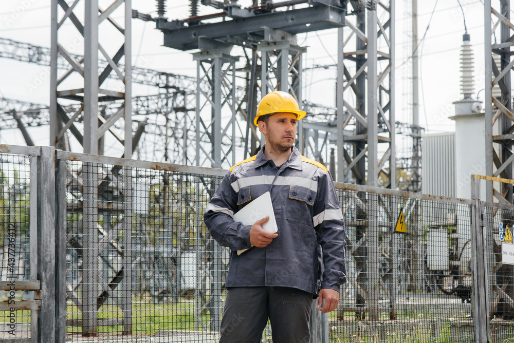 The energy engineer inspects the equipment of the substation. Power engineering. Industry The energy engineer inspects the equipment of the substation. Power engineering. Industry