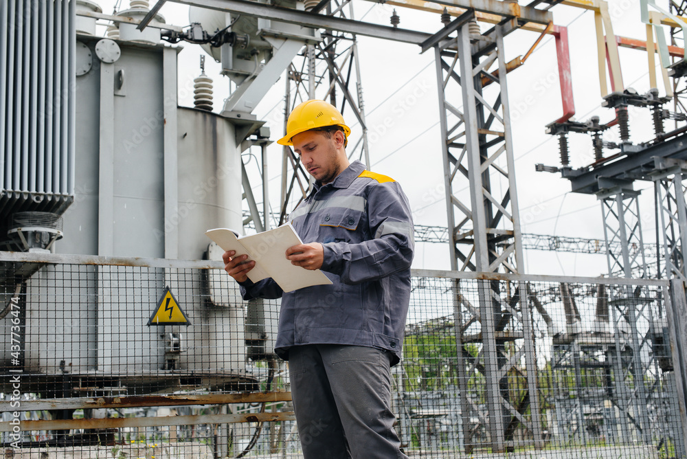 The energy engineer inspects the equipment of the substation. Power engineering. Industry The energy engineer inspects the equipment of the substation. Power engineering. Industry