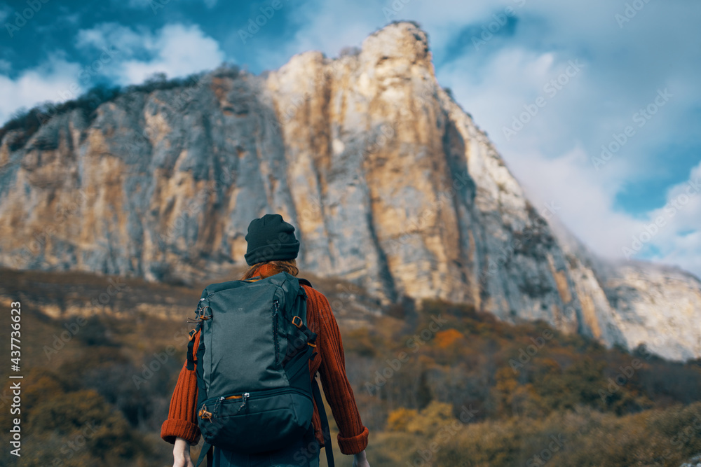 Naklejka premium woman hiker backpack travel mountains clouds nature