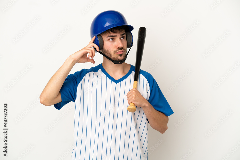 Young caucasian man playing baseball isolated on white background having doubts and thinking Young caucasian man playing baseball isolated on white background having doubts and thinking