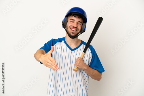 Young caucasian man playing baseball isolated on white background shaking hands for closing a good deal