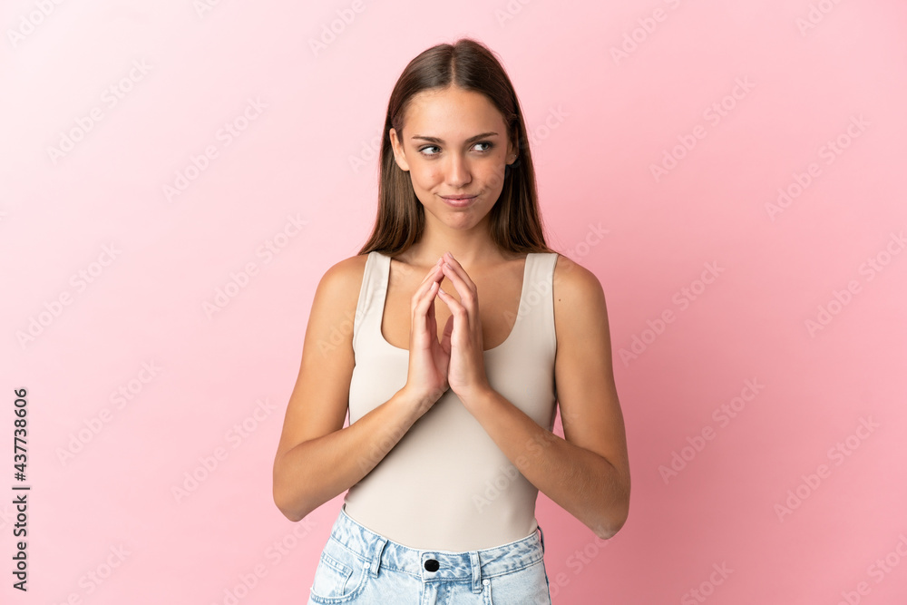 Young woman over isolated pink background scheming something Young woman over isolated pink background scheming something