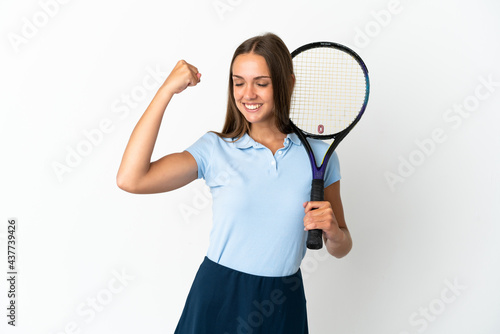 Woman playing tennis over isolated white wall doing strong gesture © luismolinero