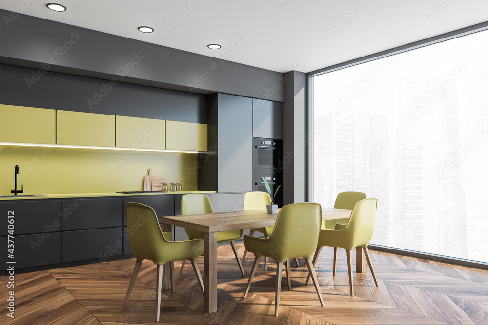 Dining table in gray and yellow kitchen with window Dining table in gray and yellow kitchen with window