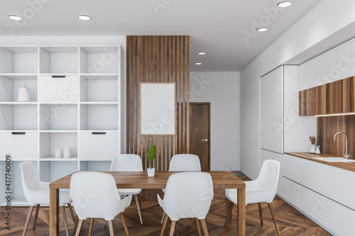 Dining table and poster in white and wooden kitchen