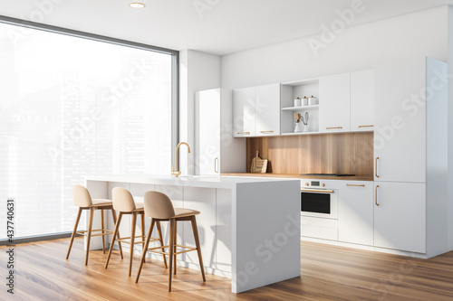 Bar with stools in white and wooden kitchen corner with window