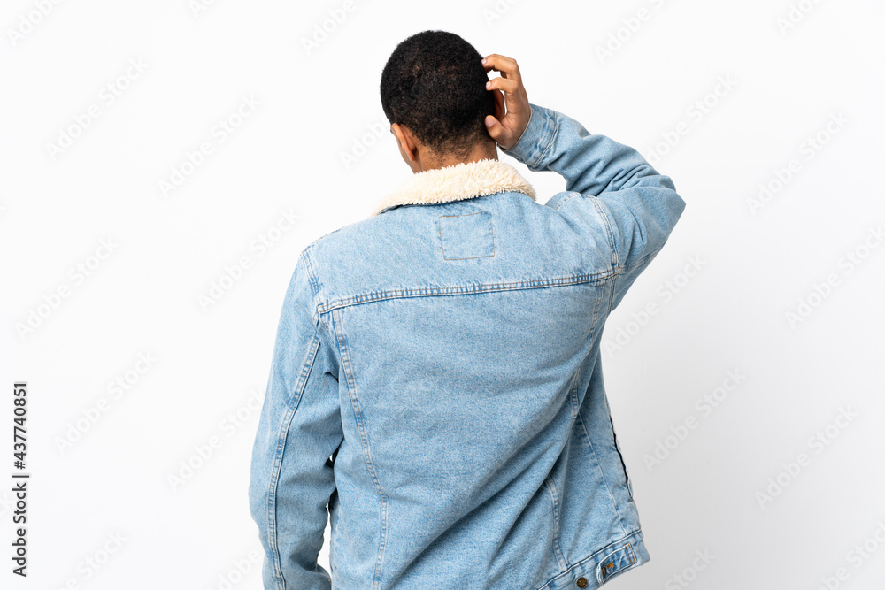 African American man over isolated white background in back position and thinking African American man over isolated white background in back position and thinking