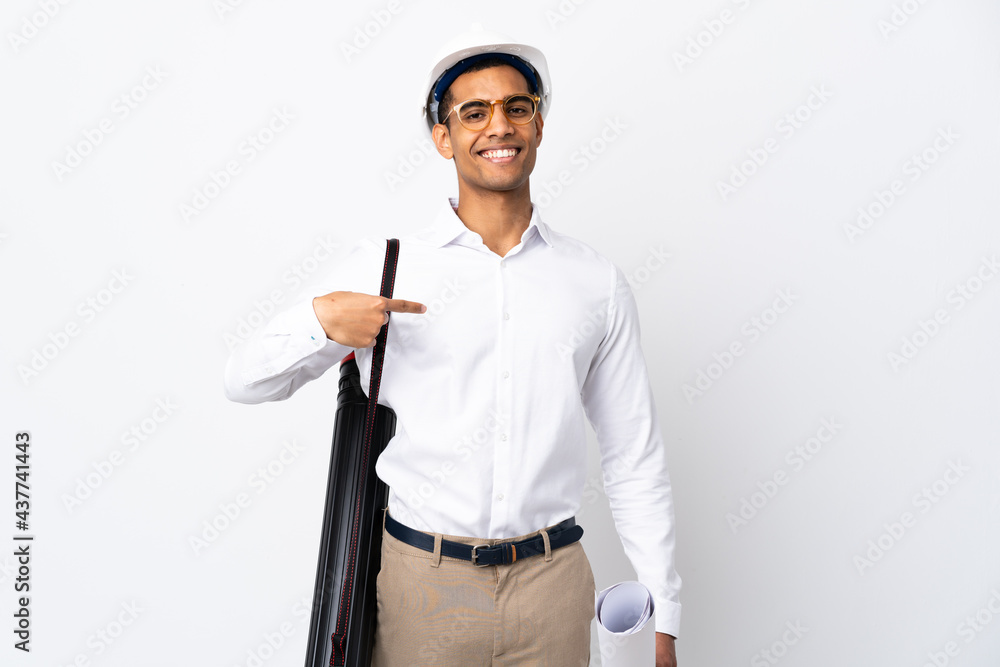 African American architect man with helmet and holding blueprints over isolated white background _ proud and self-satisfied African American architect man with helmet and holding blueprints over isolated white background _ proud and self-satisfied