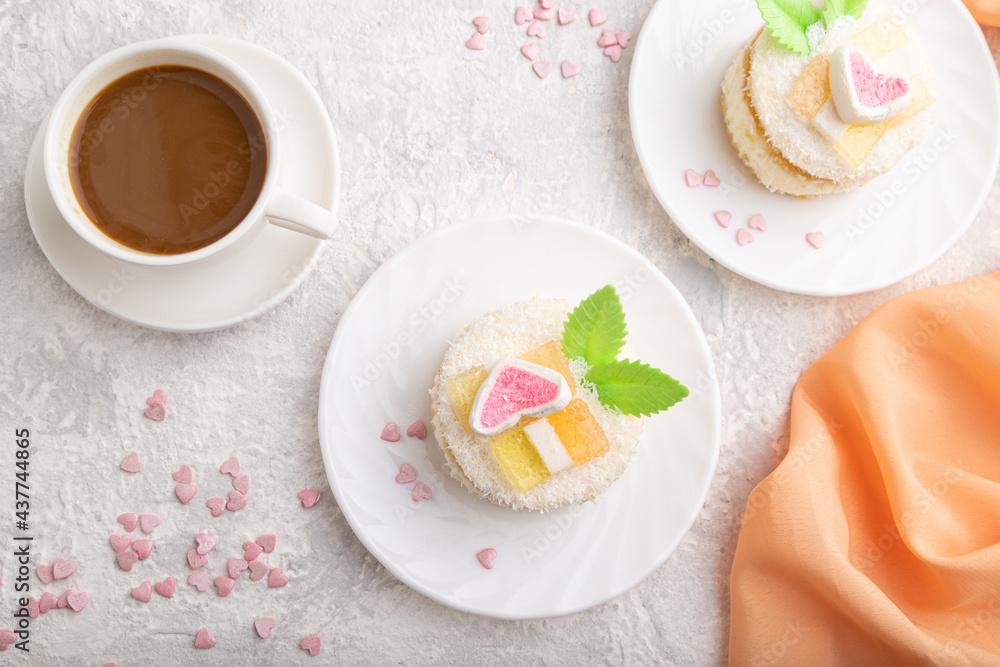 Decorated cake with milk and coconut cream with cup of coffee on a gray concrete background. top view. Decorated cake with milk and coconut cream with cup of coffee on a gray concrete background. top view.