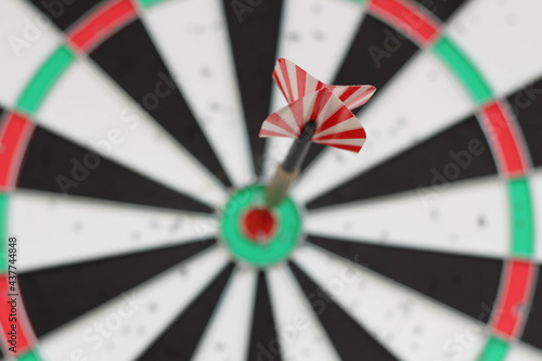 Conceptual photo. Darts on dart board outdoors in summer. Throw darts at the target. The winner, first place. Business target or goal success and winner concept.