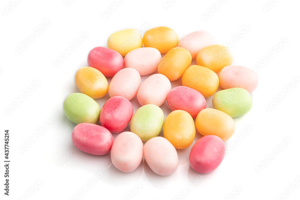 Heap of multicolored caramel candies isolated on white background, side view. Heap of multicolored caramel candies isolated on white background, side view.