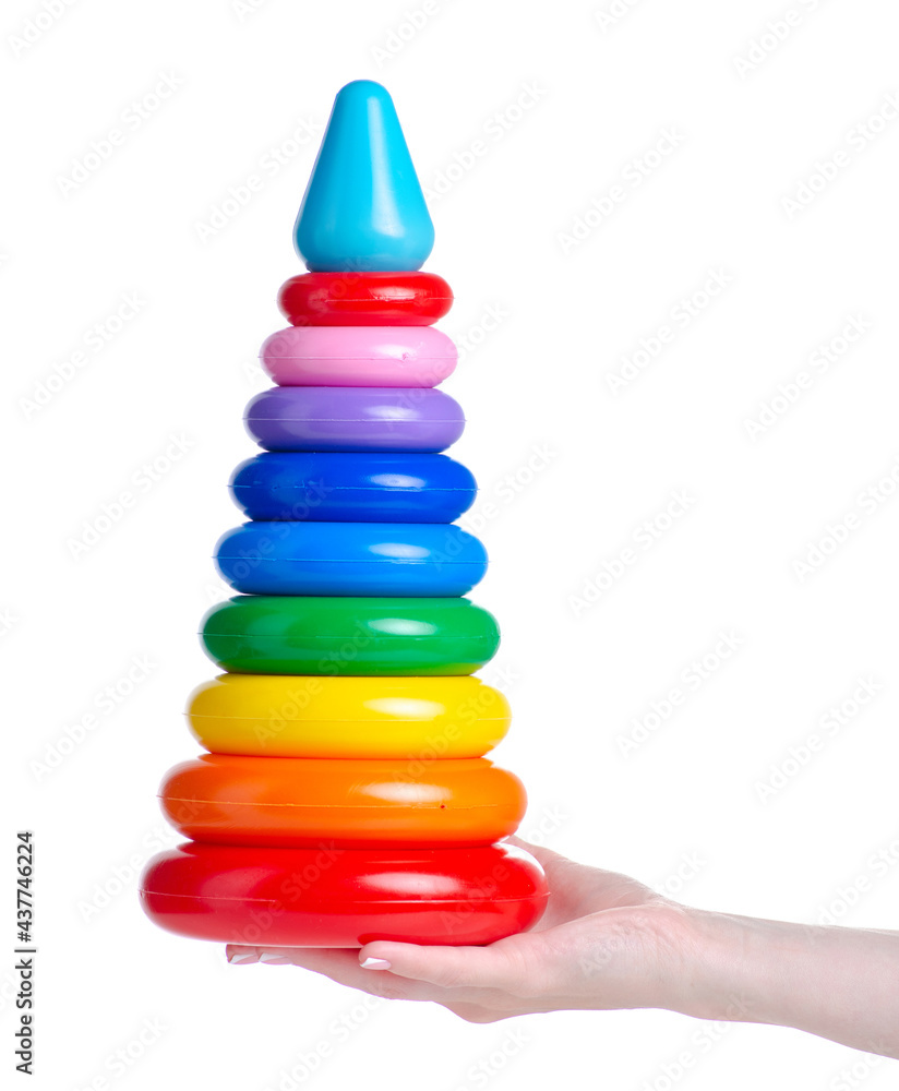 Toy children's pyramid in hand on white background isolation Toy children's pyramid in hand on white background isolation