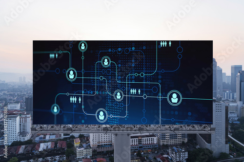 Glowing Social media icons on billboard over sunset panoramic city view of Kuala Lumpur, Malaysia, Asia. The concept of networking and establishing new connections between people and businesses in KL photo