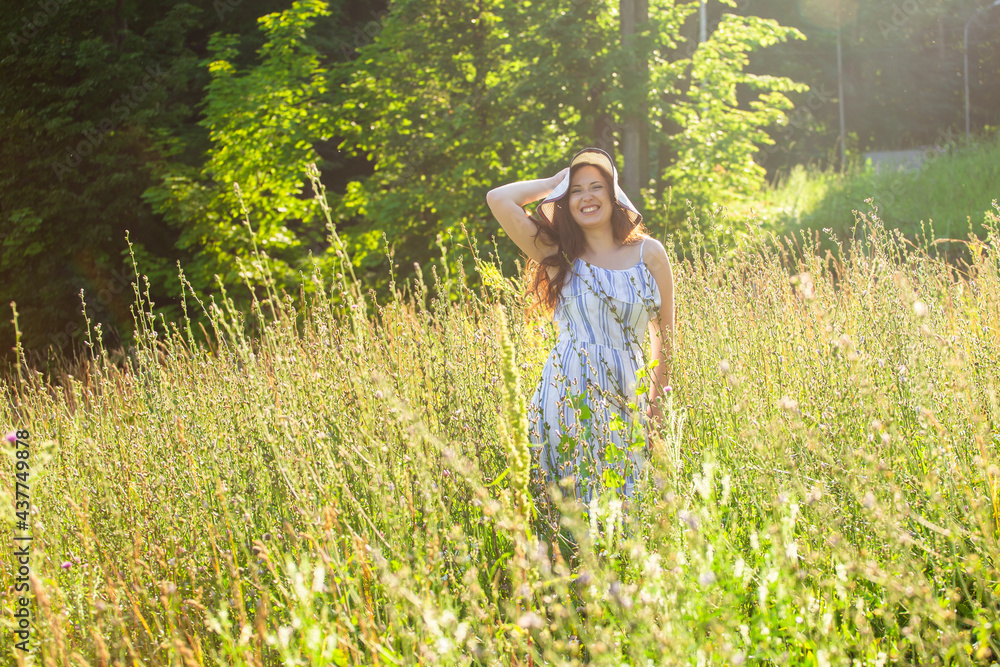 Woman walking in a field in summer sunny day. Woman walking in a field in summer sunny day.