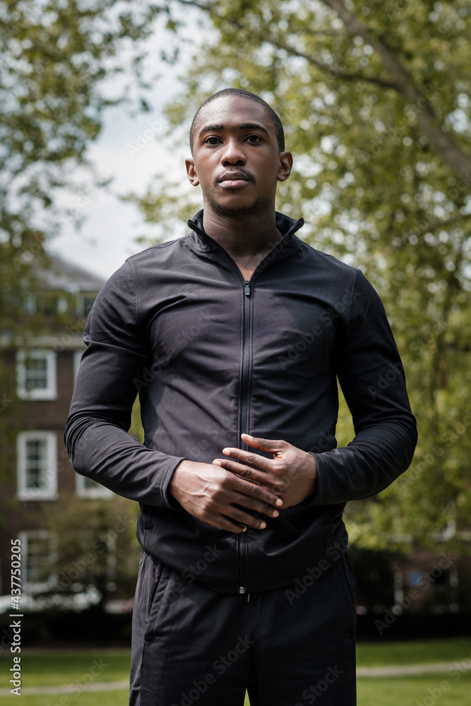 Portrait of black male athlete posing in a park.