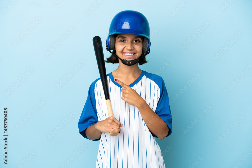 Baseball mixed race player woman with helmet and bat isolated on blue background pointing to the side to present a product Baseball mixed race player woman with helmet and bat isolated on blue background pointing to the side to present a product