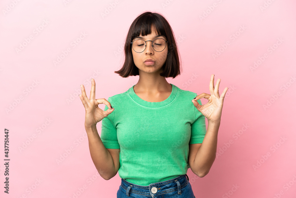 Young mixed race woman isolated on pink background in zen pose Young mixed race woman isolated on pink background in zen pose