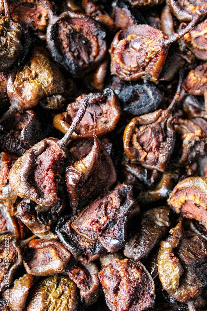 Vertical shot of dark brown dried pears. Dry pears. Fruit. Vertical shot of dark brown dried pears. Dry pears. Fruit.